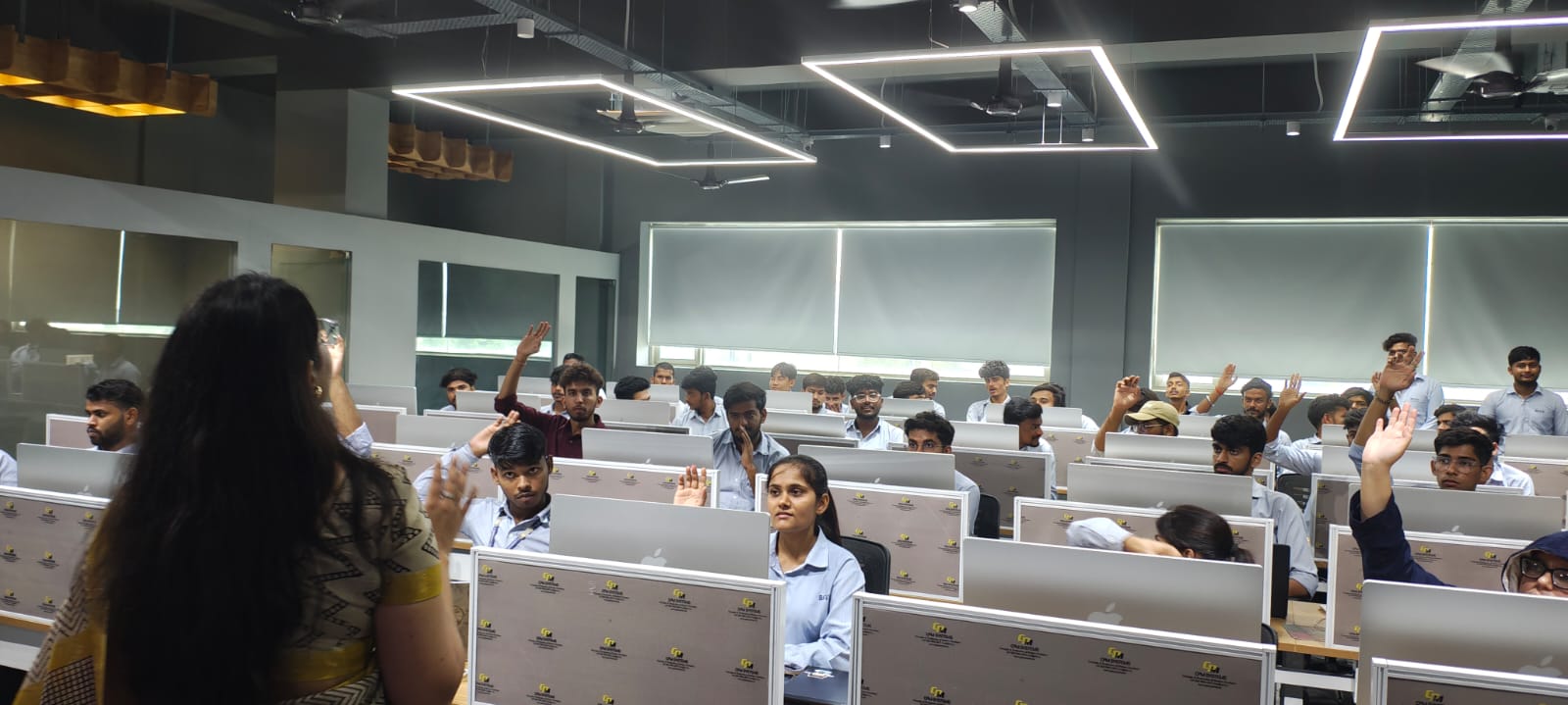 Students raising hands during an interactive training session