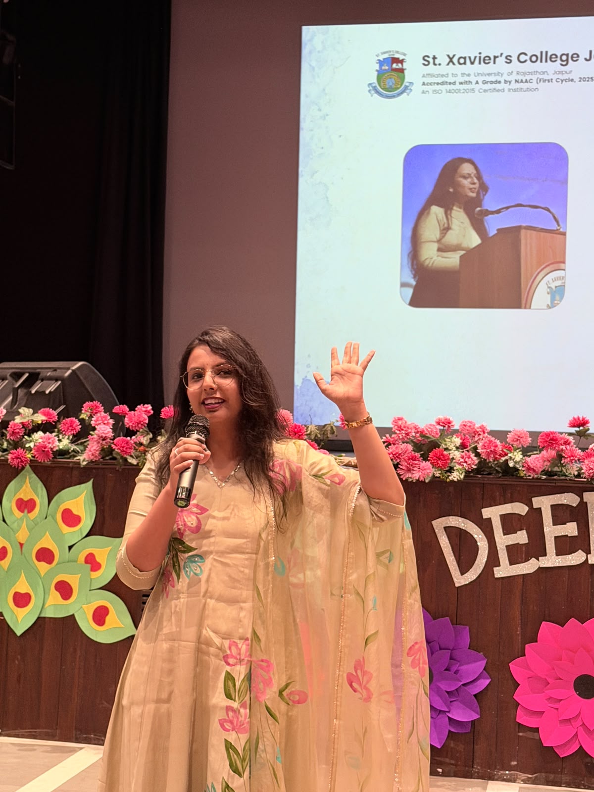 Harshita Agarwal speaking on stage at a college event